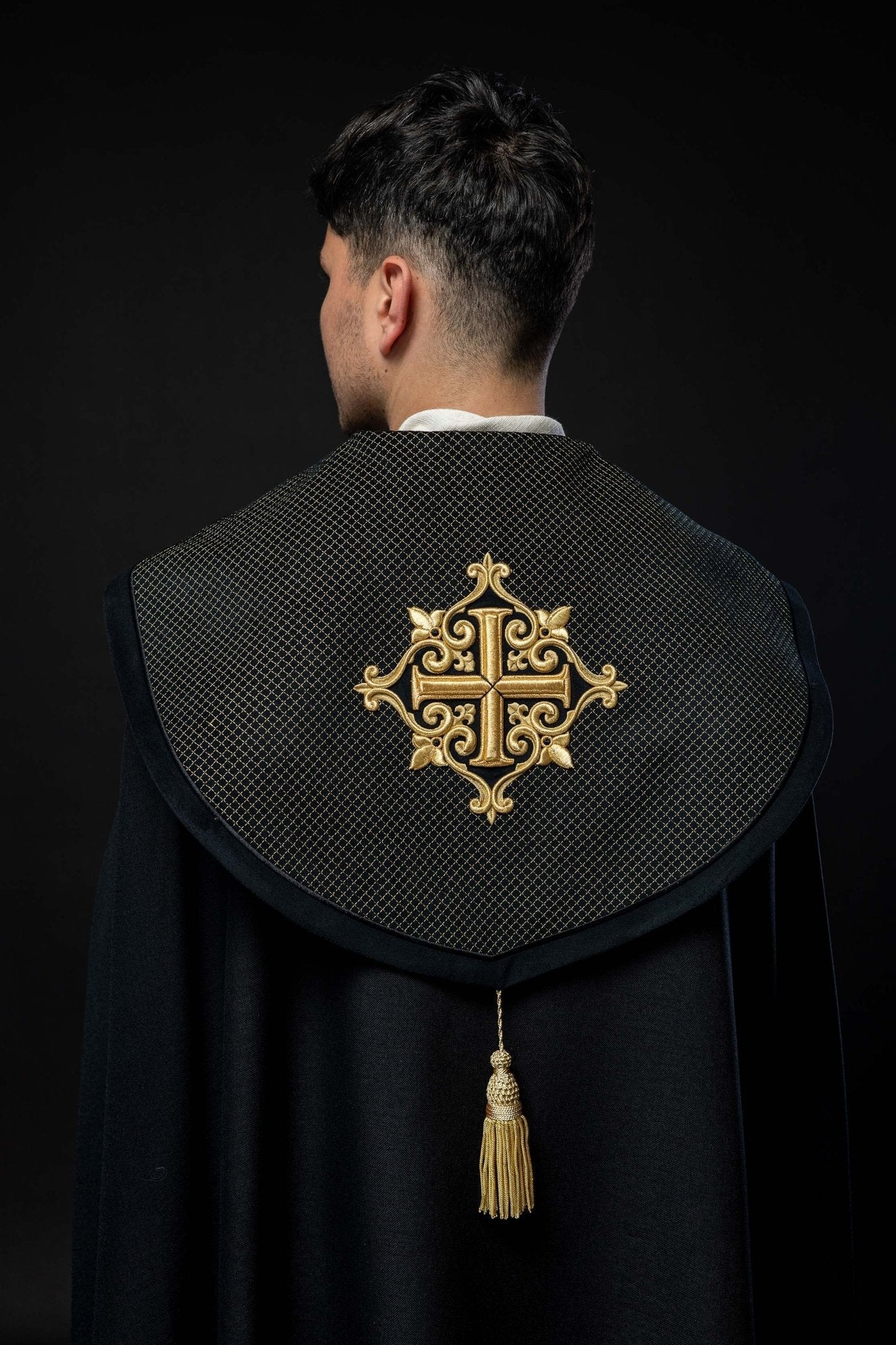 Black cope with a velvet sash and cross embroidery