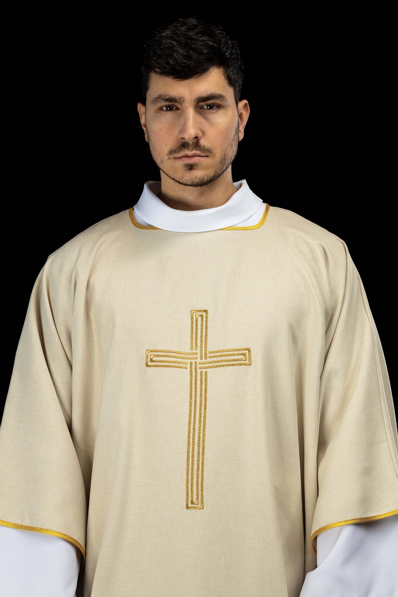 Ecru dalmatic with an embroidered gold cross