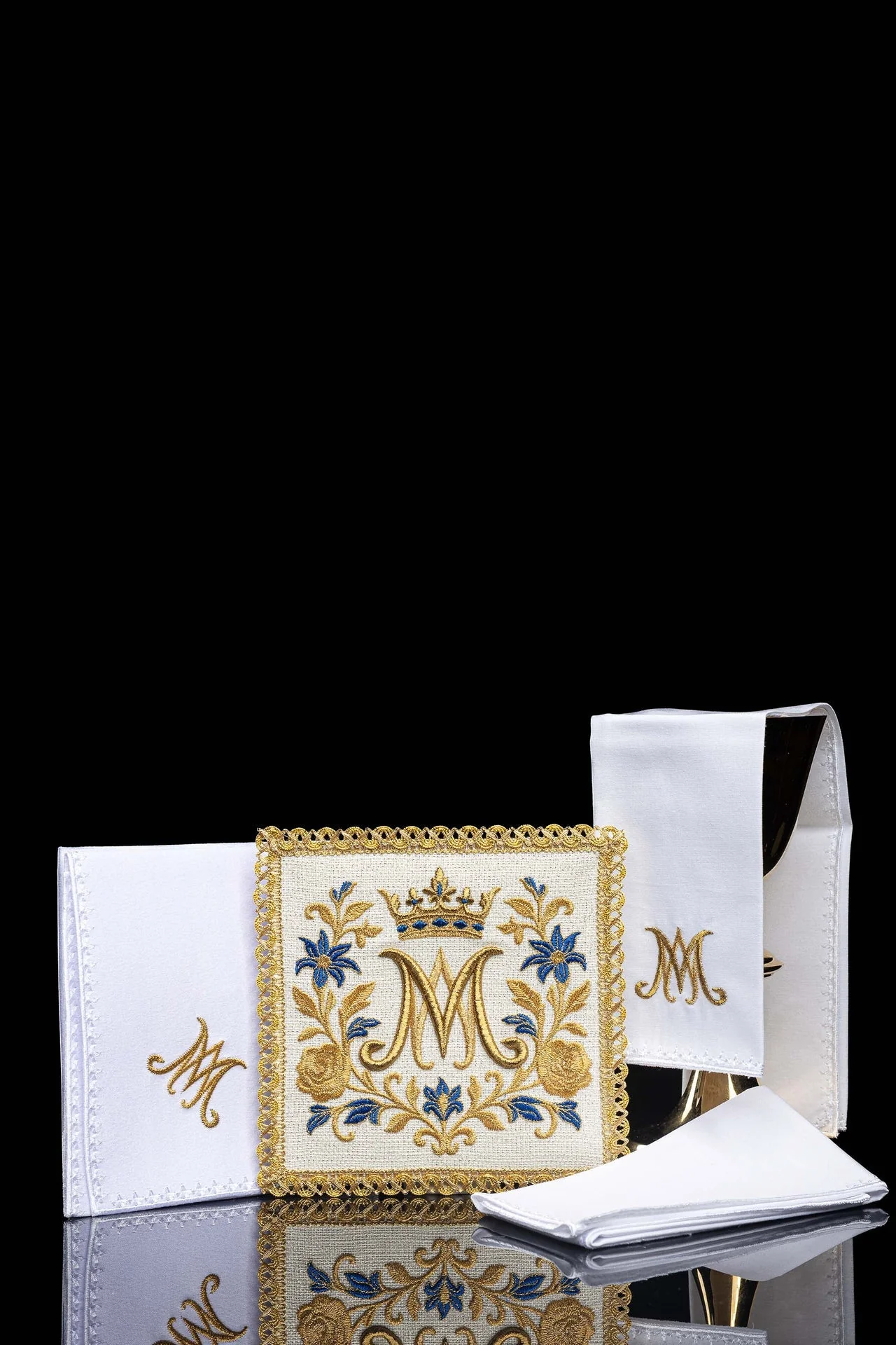 Embroidered chalice linens set with a Marian symbol