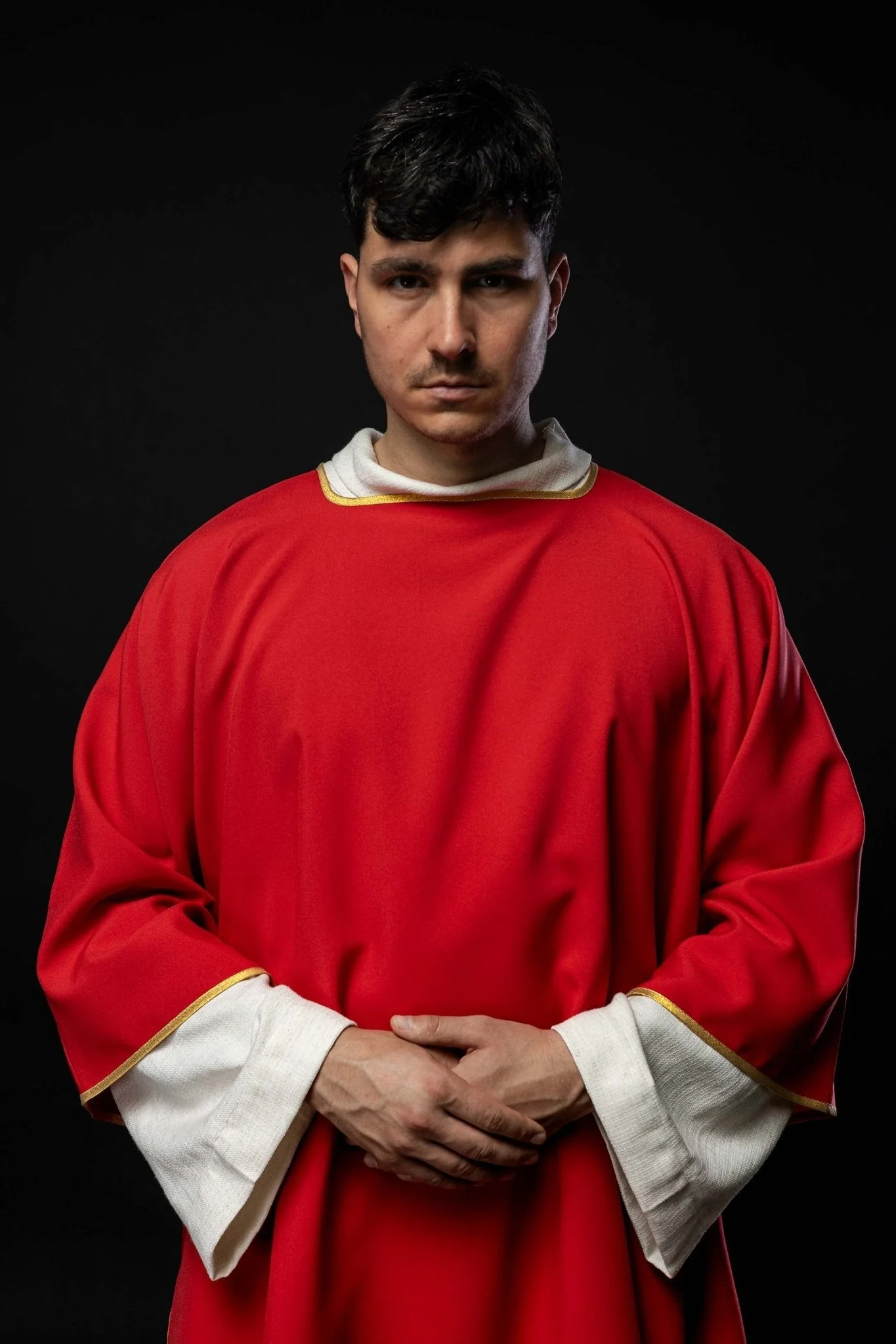 Plain dalmatic in red with gold trim