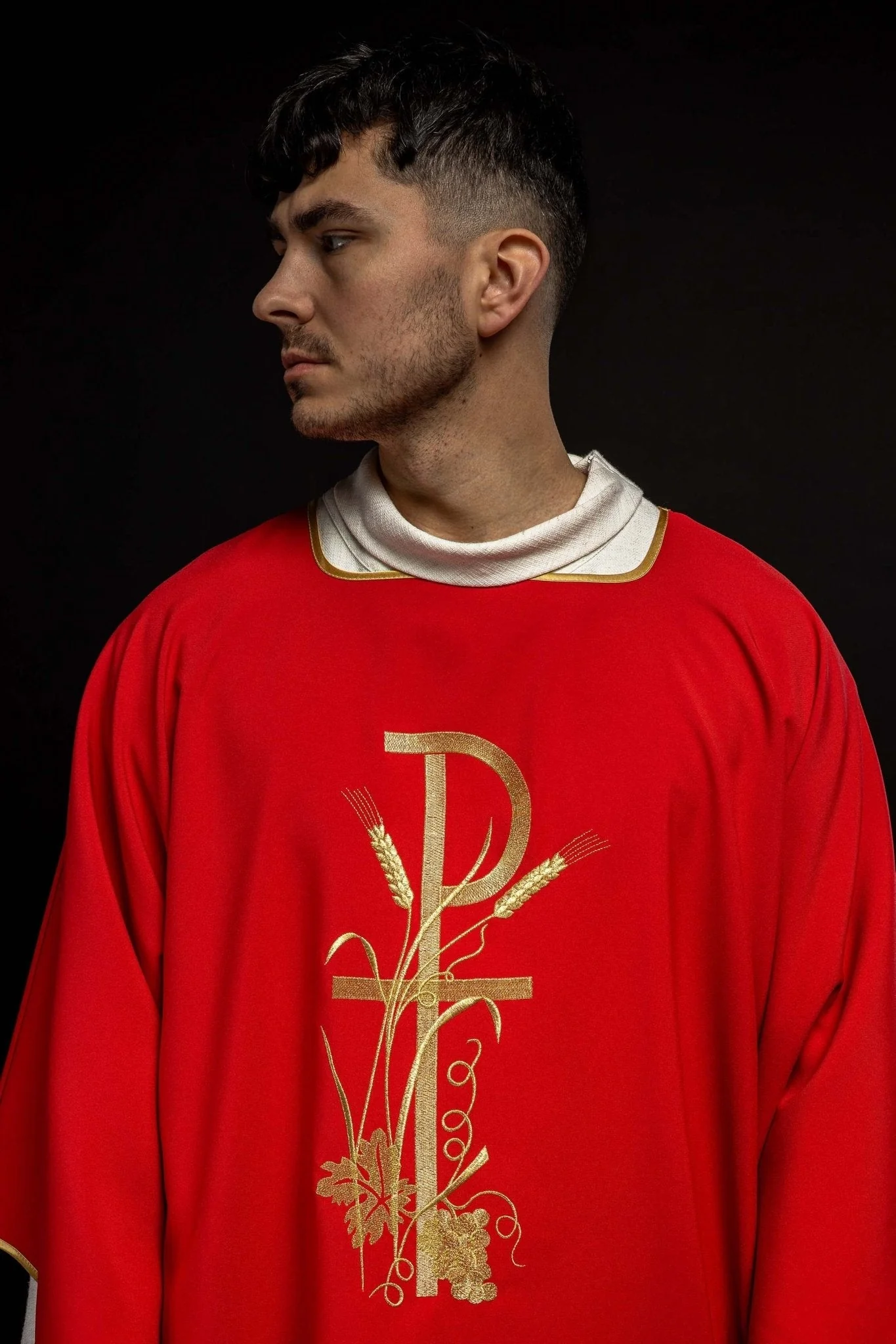 Red dalmatic with golden embroidery of the Pax cross