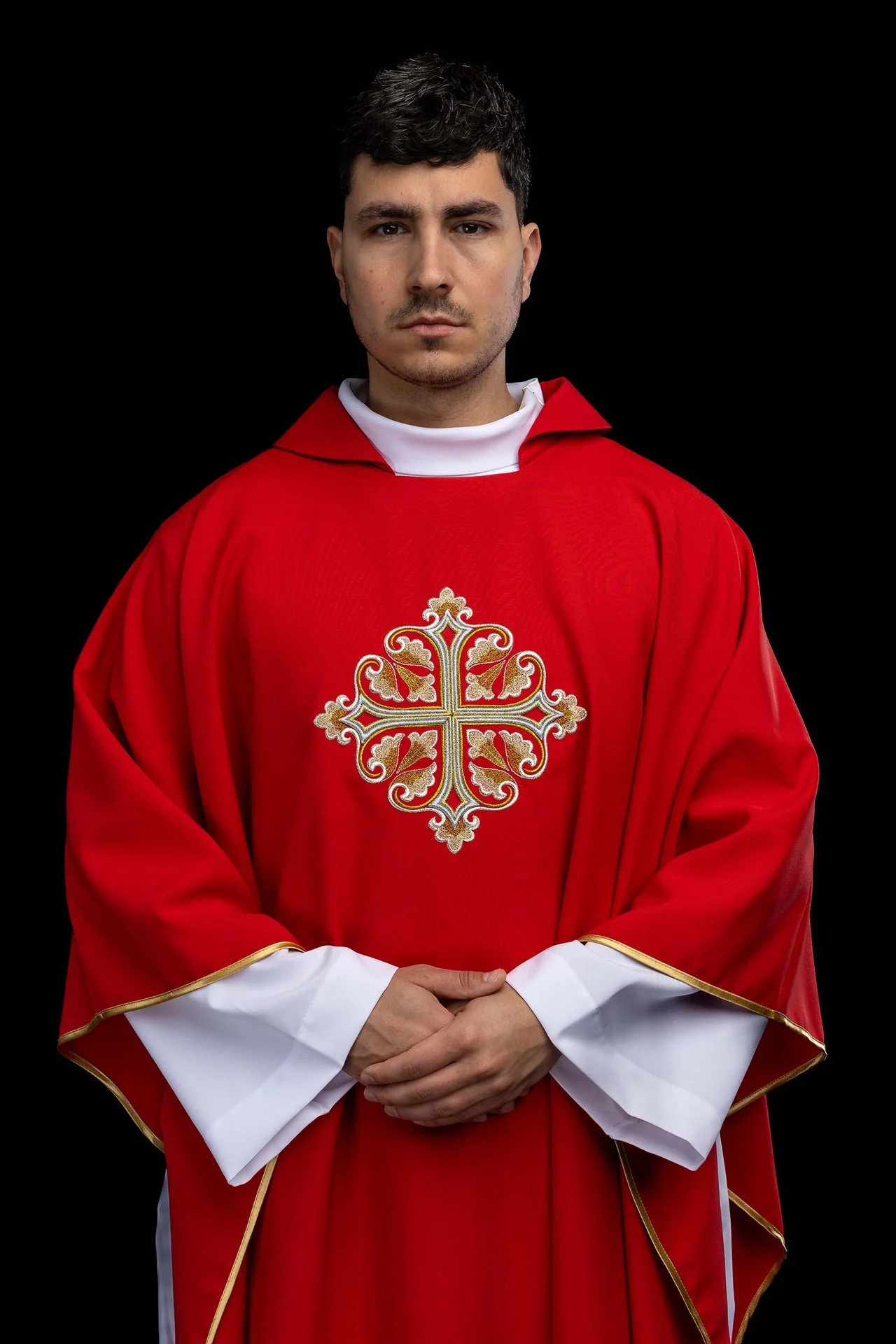 Red embroidered chasuble with an ornate cross and a wide collar