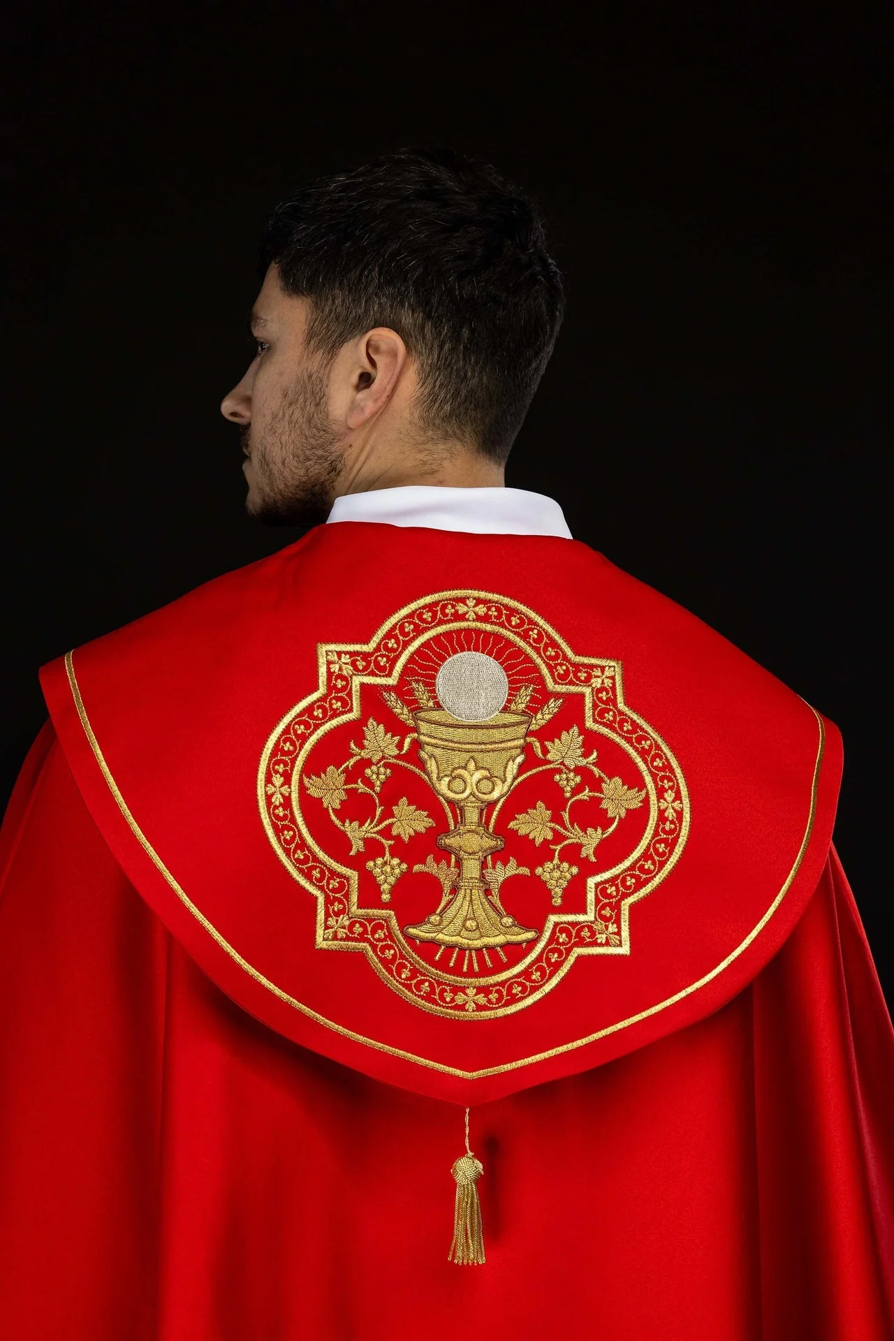 Red embroidered liturgical cope with a chalice motif